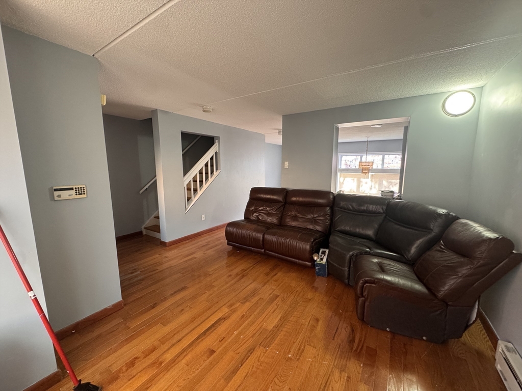 100 Lawn Street, Unit 100 Boston, MA 02120 - Photo 5 of 40 a living room with furniture and a wooden floor