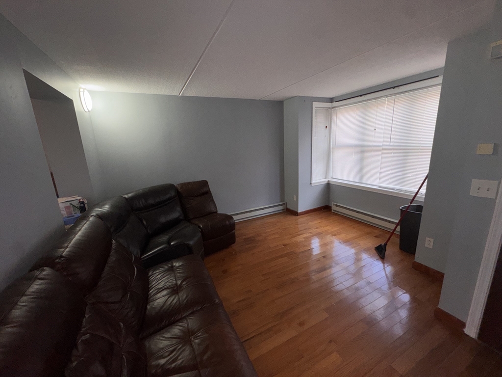 100 Lawn Street, Unit 100 Boston, MA 02120 - Photo 7 of 40 a room with furniture and a window