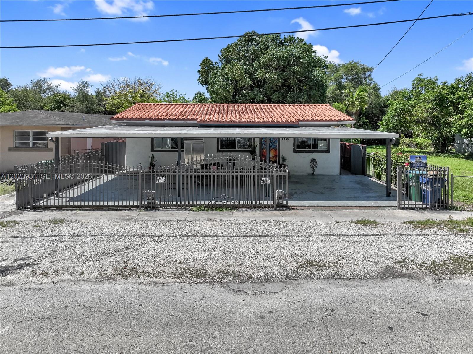 1360 Northwest 77th Street Miami, FL 33147 - Photo 1 of 41 a front view of a house with a garden
