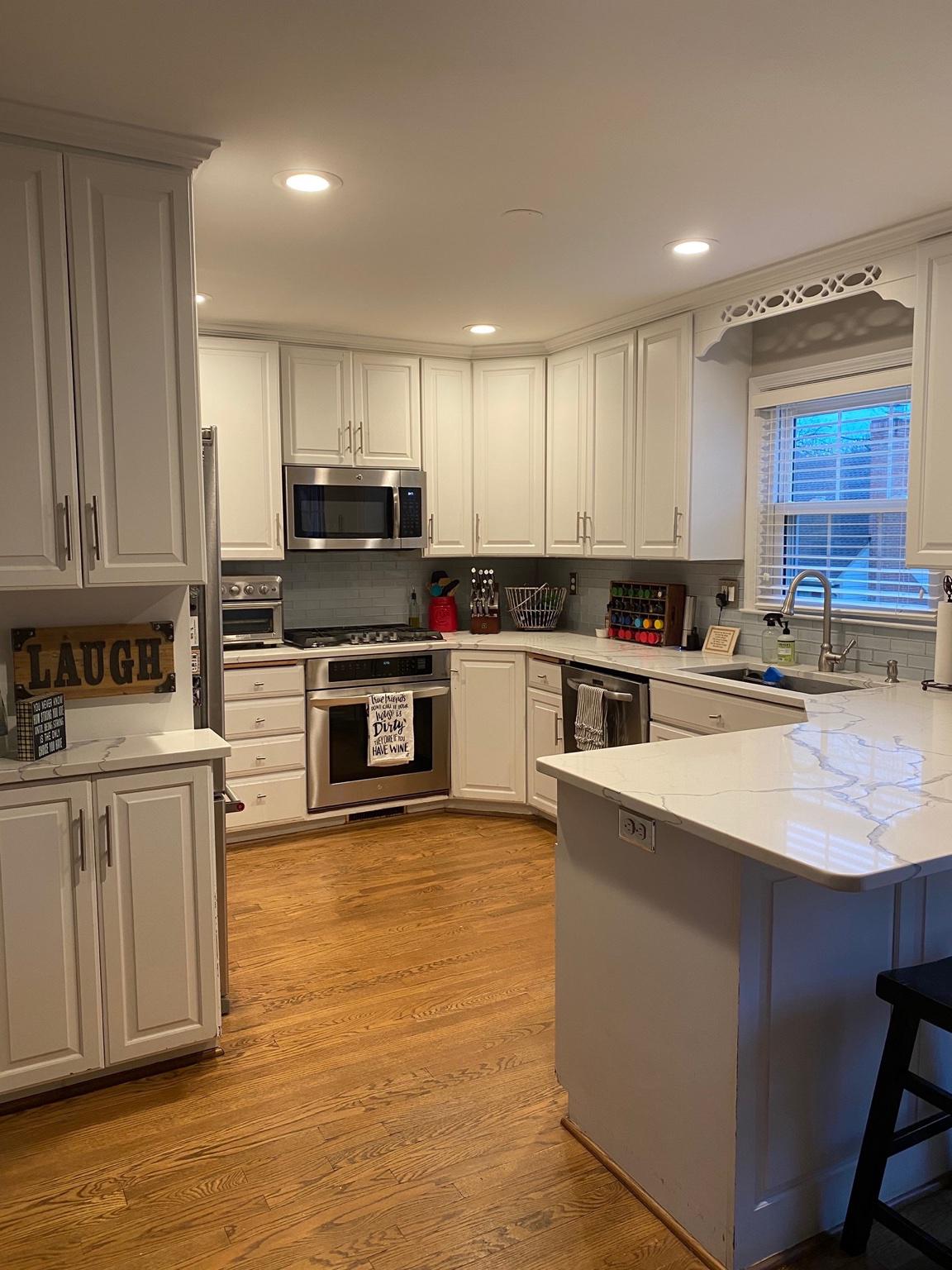 5423 Rilian Court Burke, VA 22015 - Photo 23 of 67 a kitchen with stainless steel appliances granite countertop a stove top oven a sink and white cabinets