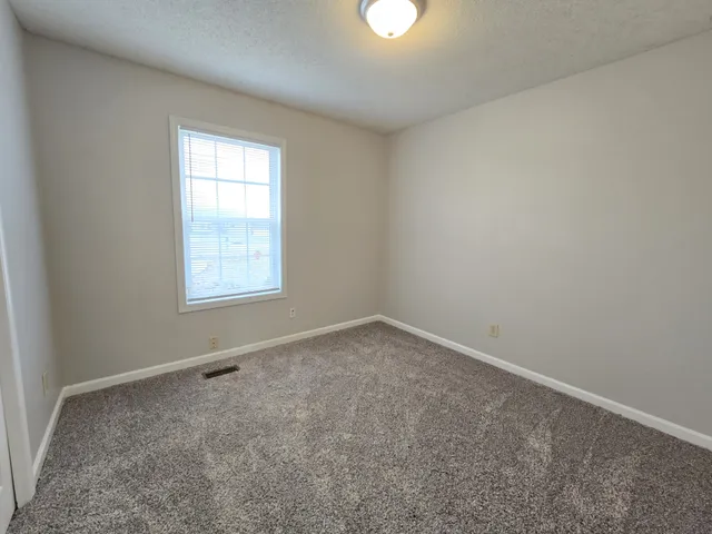 a view of an empty room and closet area