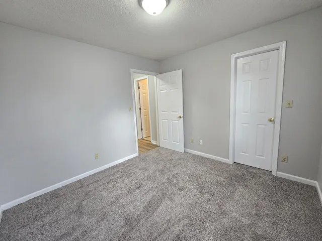 a balcony with wooden floor and fence