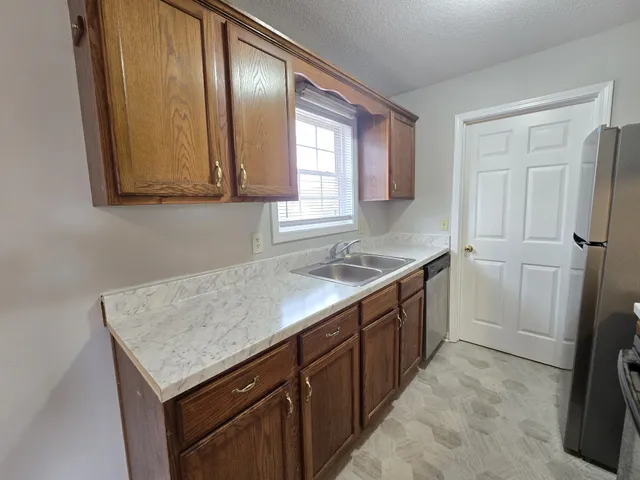 a kitchen with a sink stove and cabinets