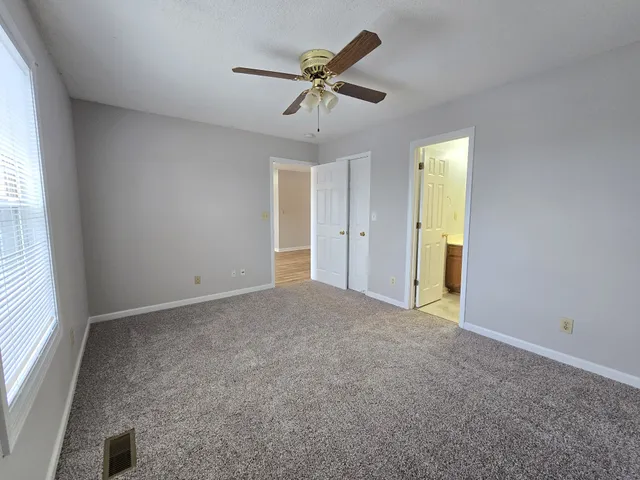 a view of a livingroom with a ceiling fan and window