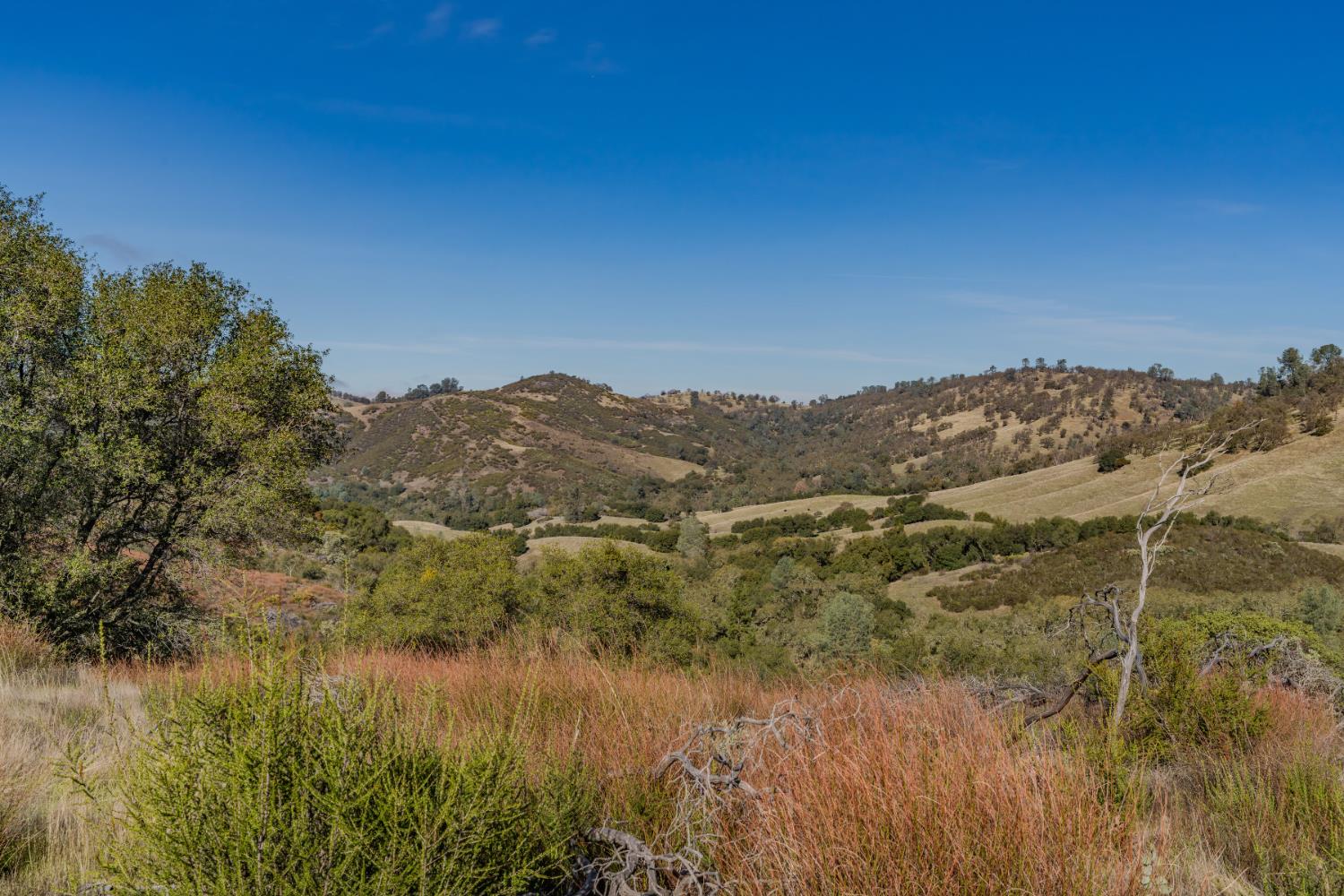 11151 Ridge Road Sutter Creek, CA 95685 - Photo 15 of 61 a view of a lake with mountains in the background