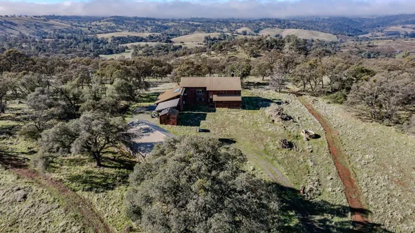 an aerial view of a house with a yard
