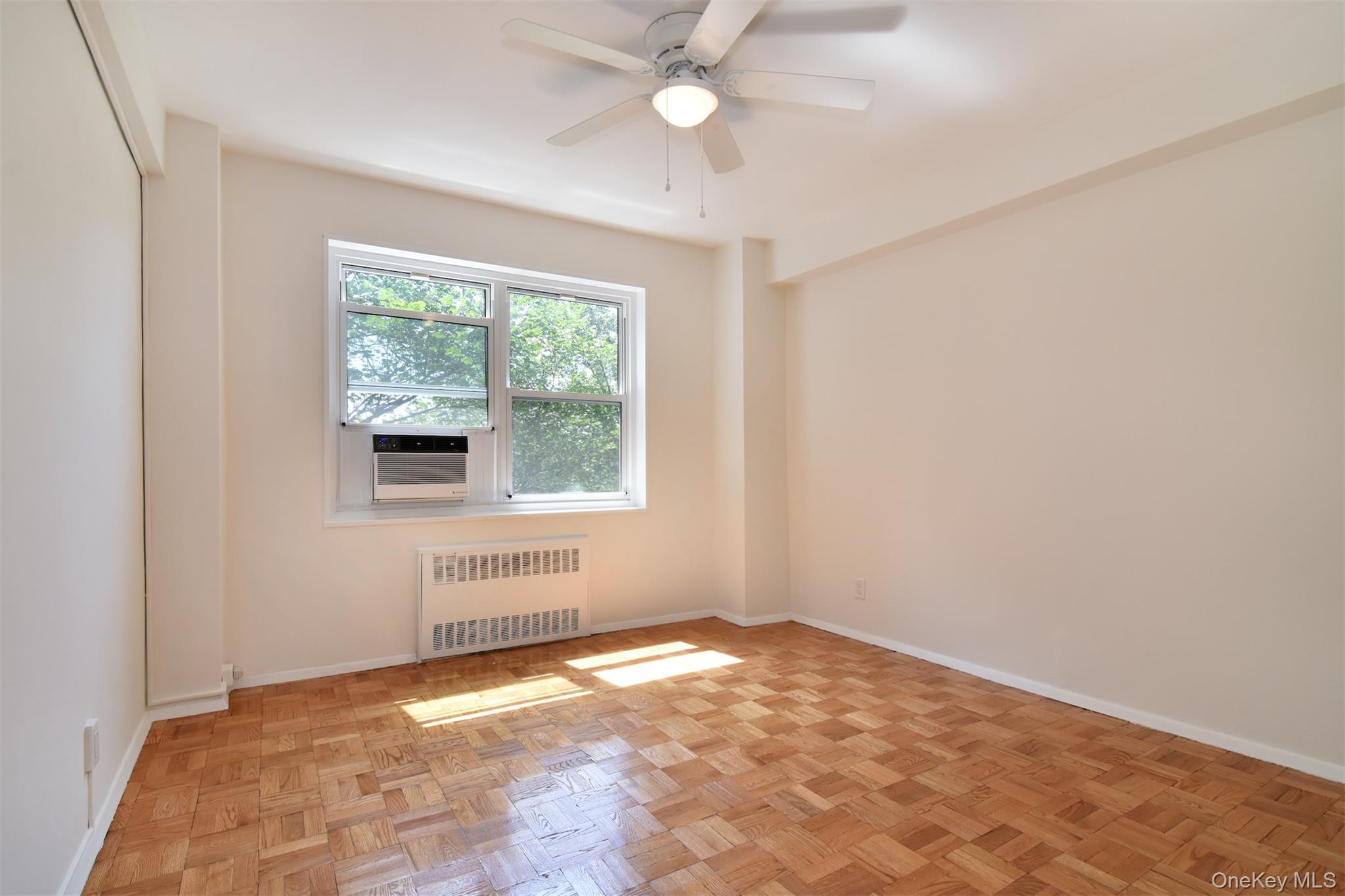 900 Palmer Road, Unit 7L Bronxville, NY 10708 - Photo 16 of 21 an empty room with a windows and ceiling fan