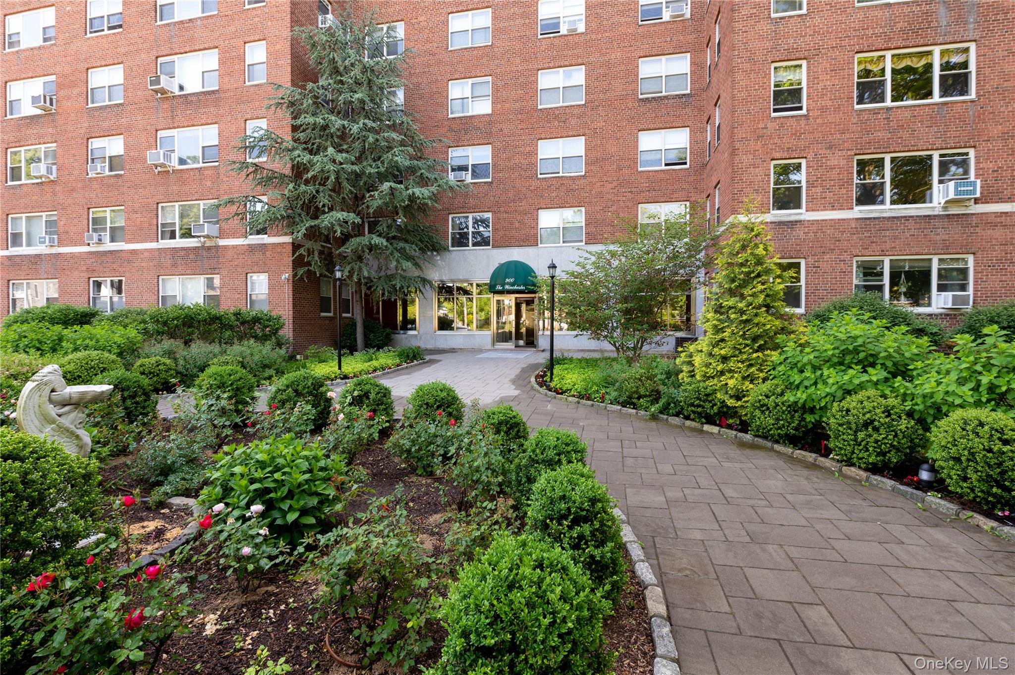 900 Palmer Road, Unit 7L Bronxville, NY 10708 - Photo 19 of 21 a view of a building next to a yard