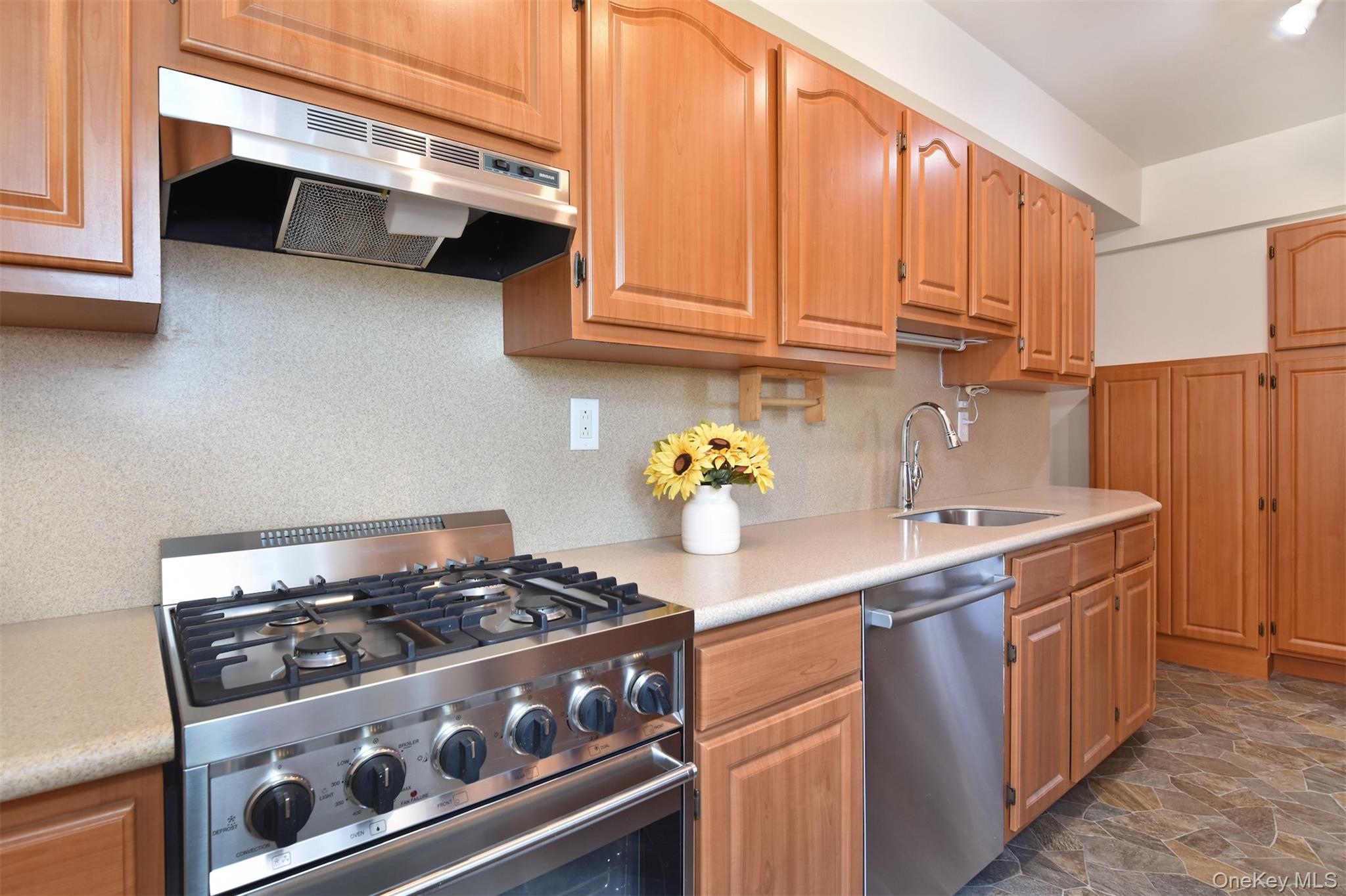 900 Palmer Road, Unit 7L Bronxville, NY 10708 - Photo 9 of 21 a kitchen with stainless steel appliances granite countertop a sink stove and cabinets