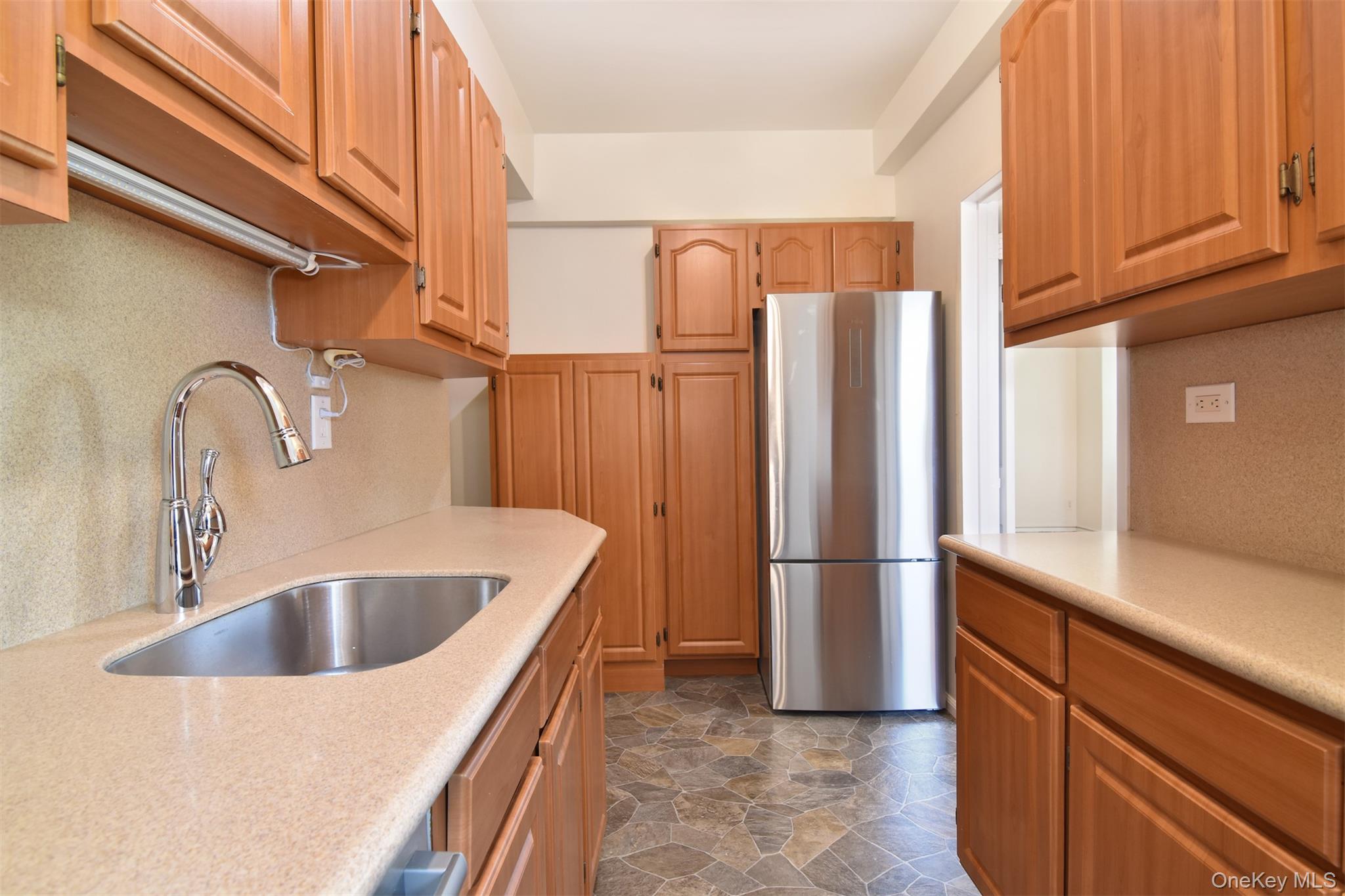 900 Palmer Road, Unit 7L Bronxville, NY 10708 - Photo 10 of 21 a kitchen with stainless steel appliances granite countertop a refrigerator and a sink