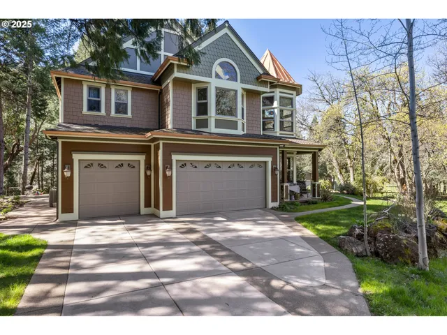 a front view of a house with a garden and yard