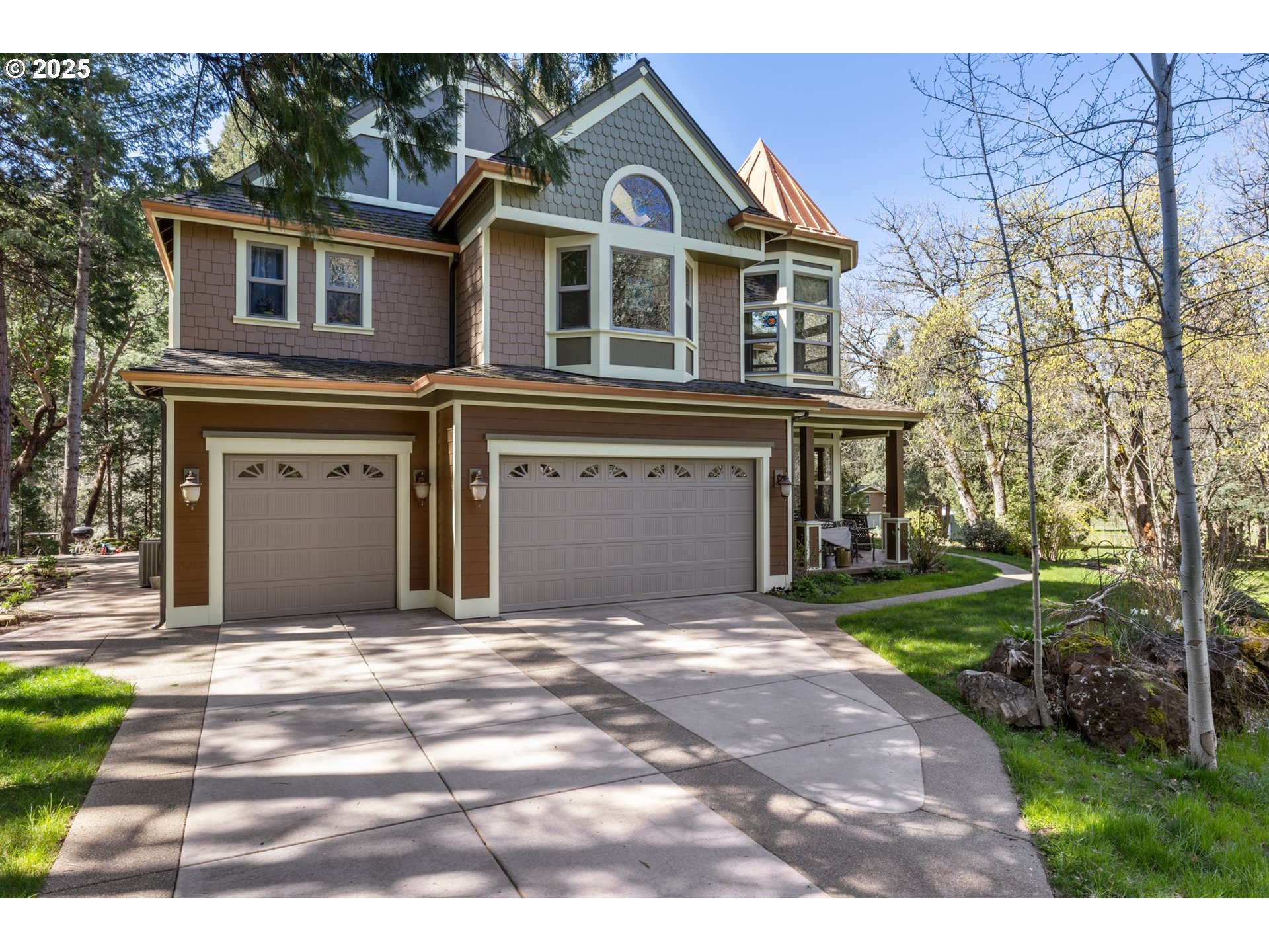 a front view of a house with a garden and yard