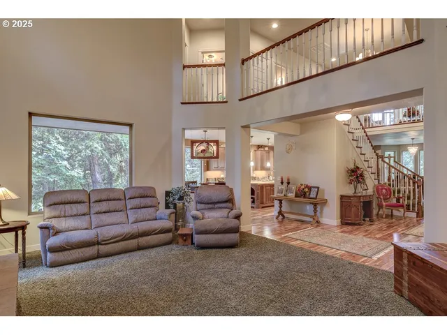a living room with furniture a window and a flat screen tv