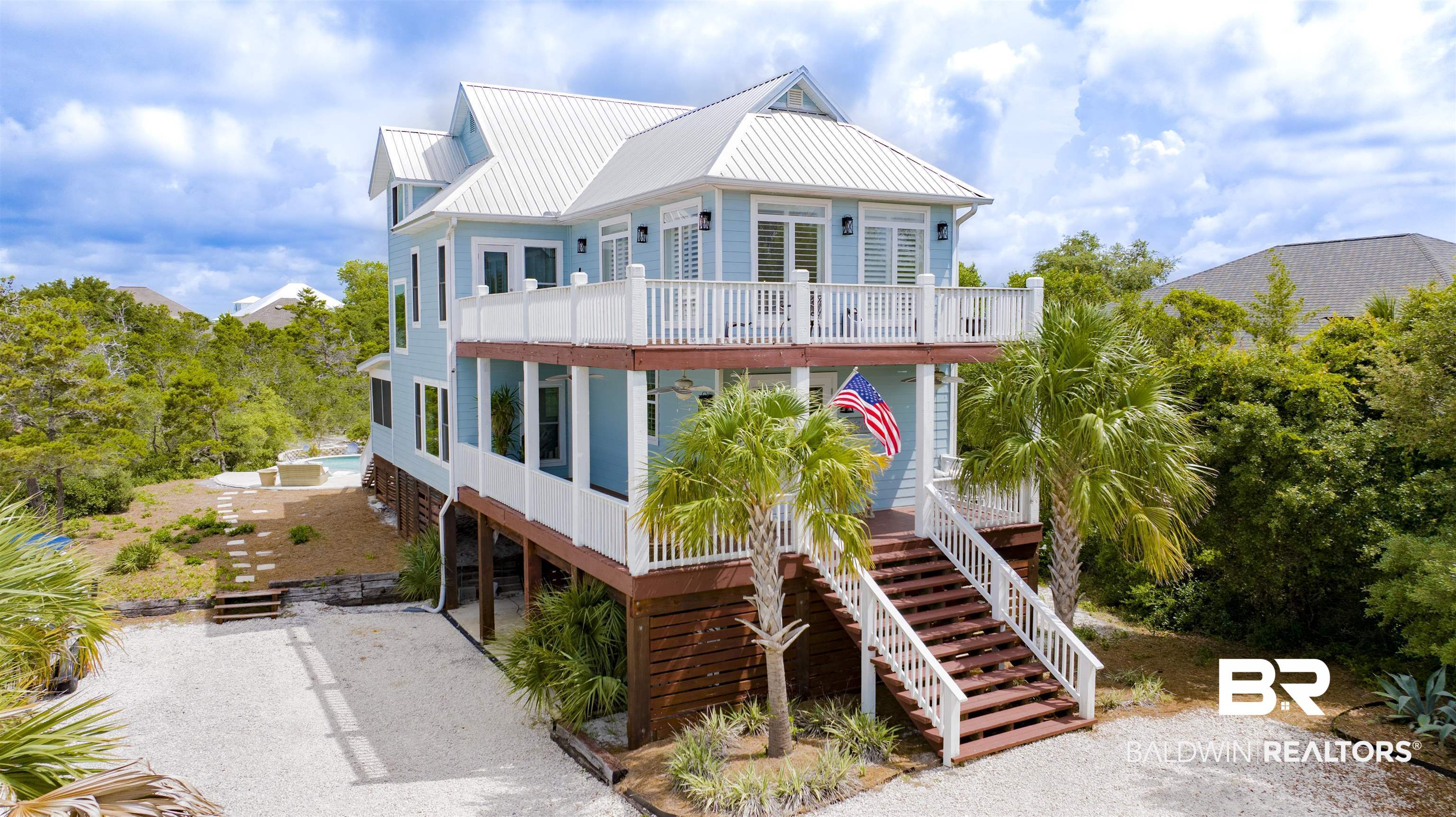 30351 River Road Orange Beach, AL 36561 - Photo 2 of 44 Coastal-inspired residence featuring light blue siding and a white metal roof