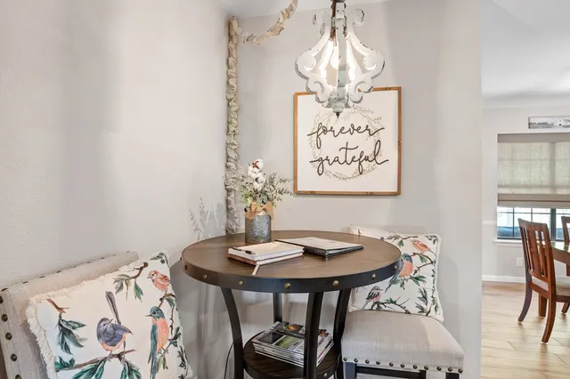 a view of a dining room with furniture and chandelier