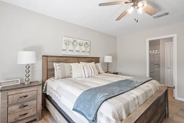 a bedroom with a bed and a chandelier