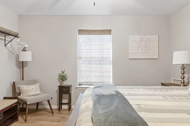 a bedroom with a bed and a chair