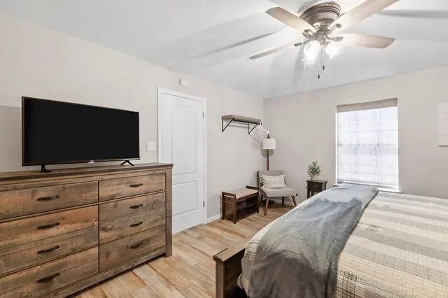 a bedroom with a bed and a flat screen tv