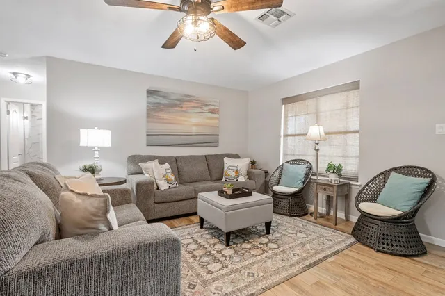 a living room with furniture and a large window