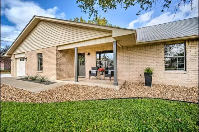 a front view of house with yard and green space
