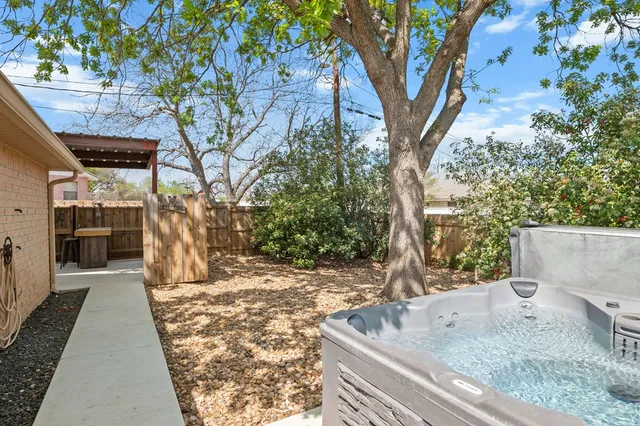 a view of a patio with table and chairs with wooden floor and fence