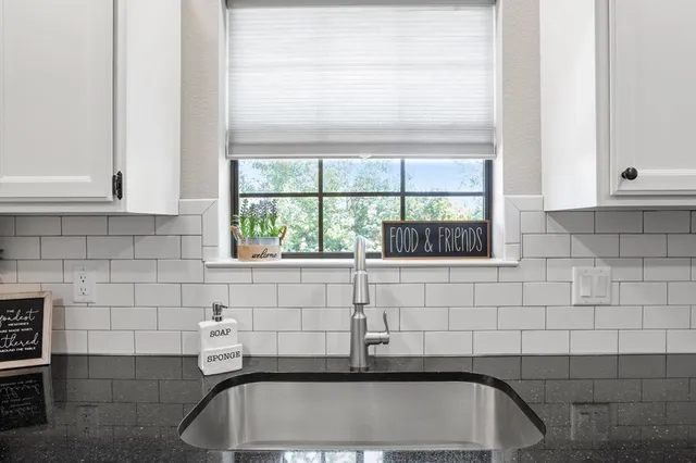 a bathroom with a sink and a window