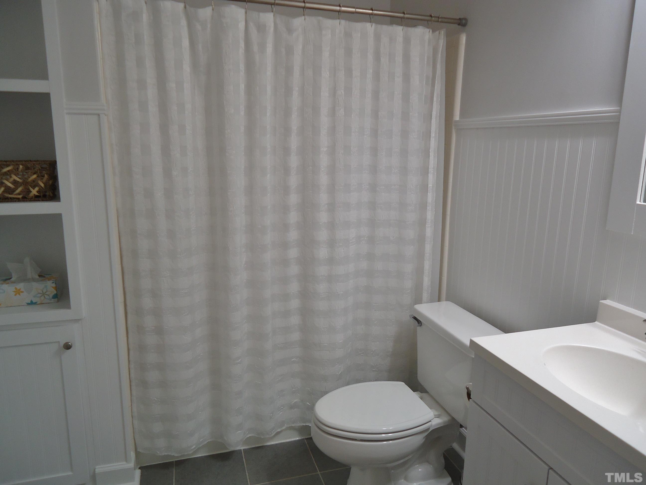 5405 Edington Lane Raleigh, NC 27604 - Photo 23 of 30 a white toilet sitting next to a small sink