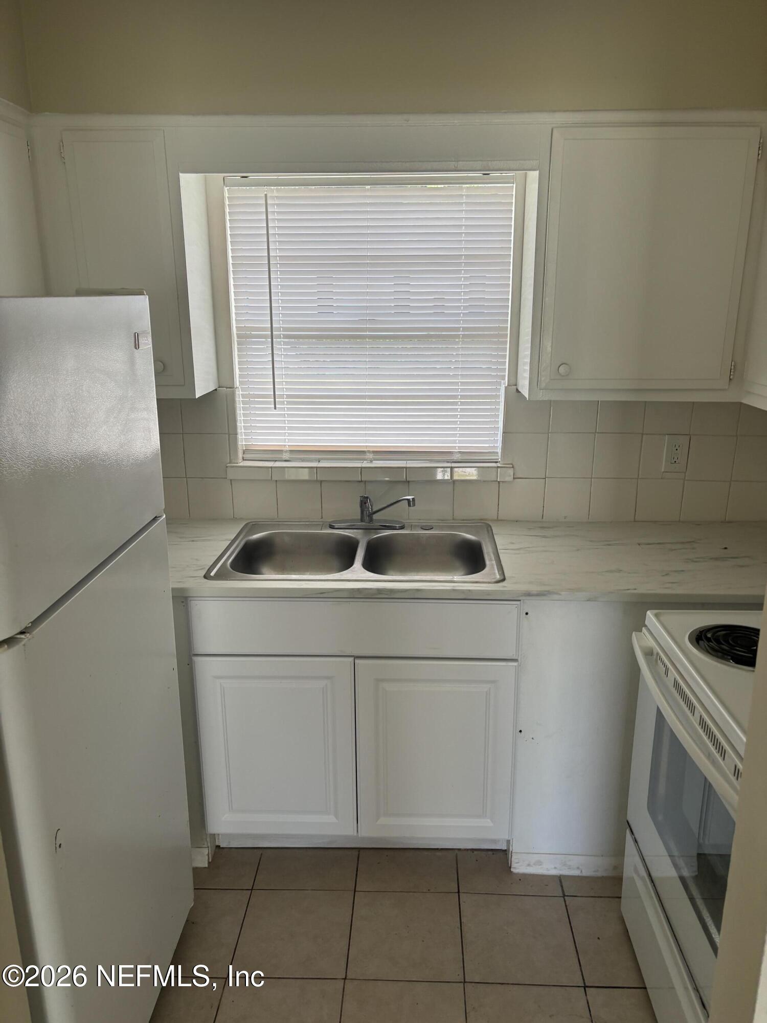 1515 Pullen Road, Unit 4 Jacksonville, FL 32216 - Photo 6 of 14 a kitchen with a sink cabinets and appliances
