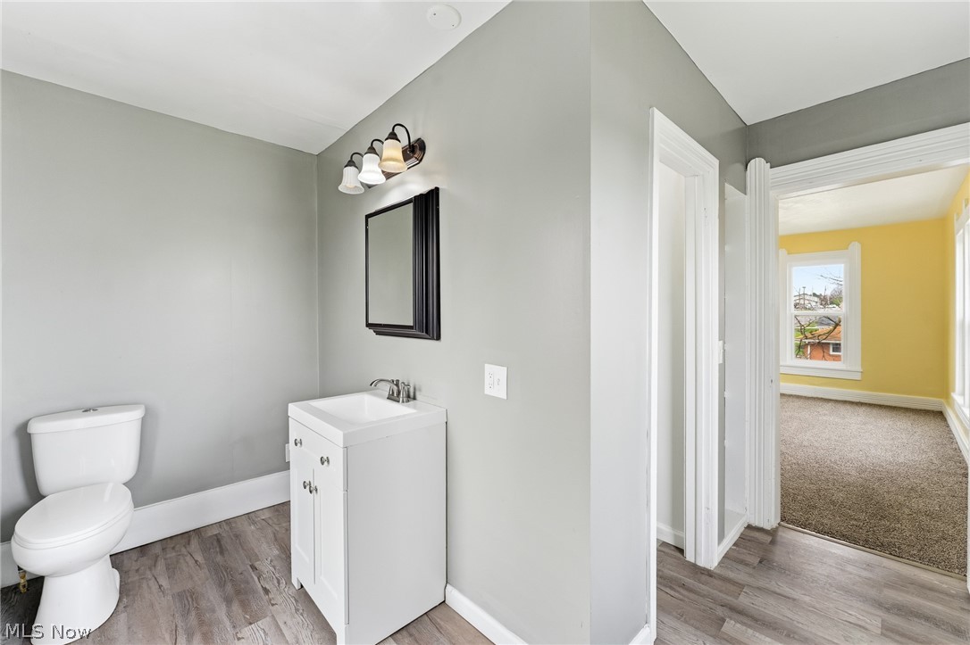563 Geneva Avenue Struthers, OH 44471 - Photo 18 of 31 Half bath with vanity and light wood-style flooring