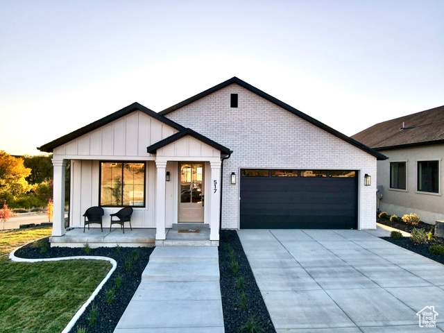 657 North Heritage Street, Unit 9 Mapleton, UT 84664 - Photo 1 of 10 Modern farmhouse featuring board and batten siding, an attached garage, driveway, brick siding, and a front yard