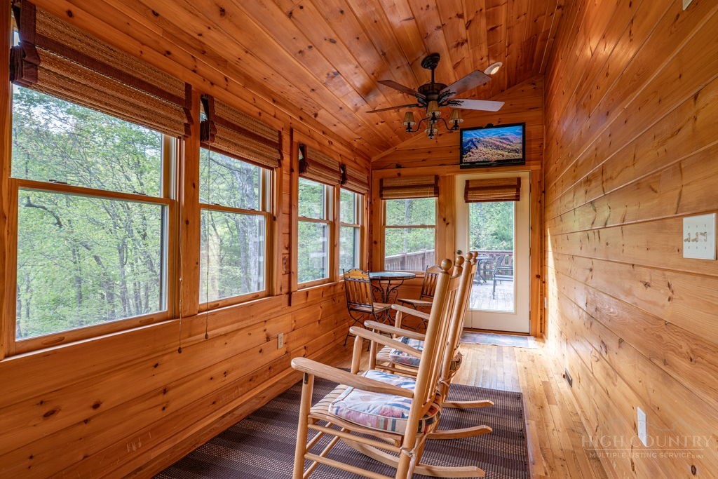 197 Woodby Ridge Road Vilas, NC 28692 - Photo 14 of 45 a dining room with wooden floor and furniture