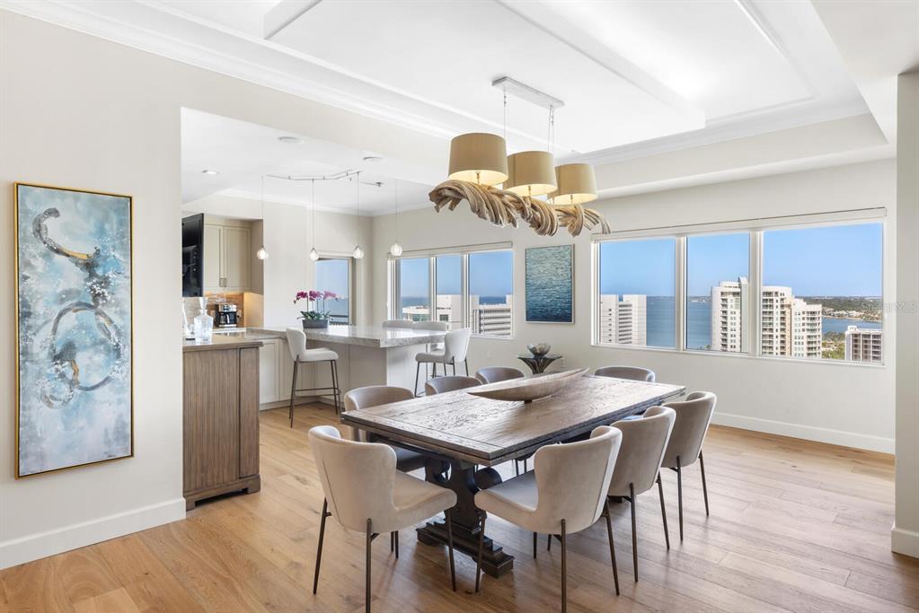 1111 Ritz Carlton Drive, Unit 1803 Sarasota, FL 34236 - Photo 16 of 65 a view of a dining room with furniture and wooden floor