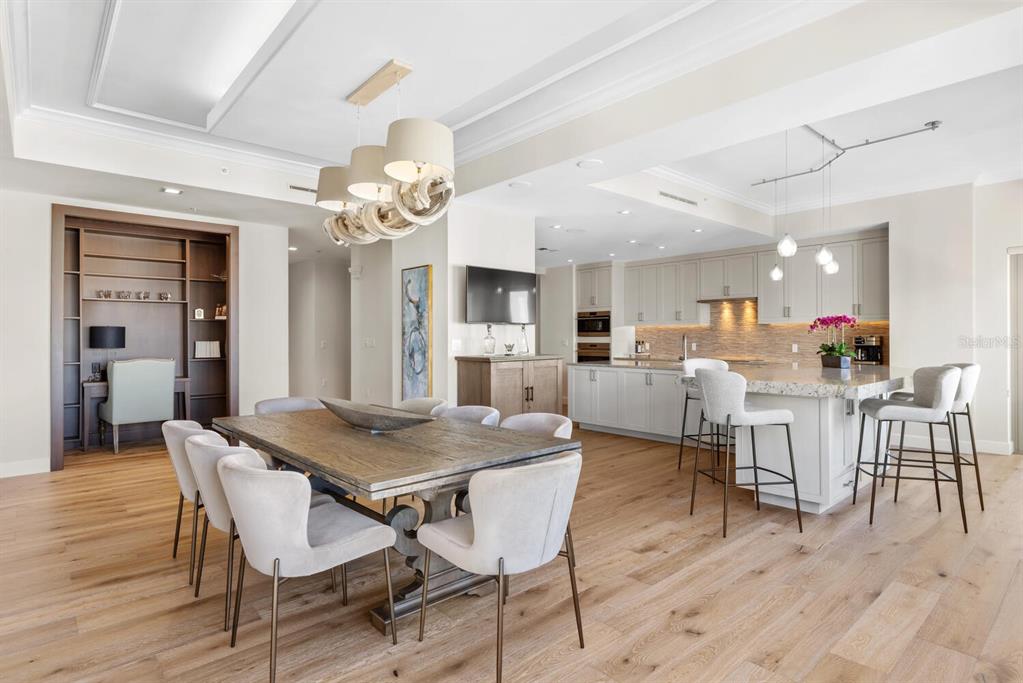 1111 Ritz Carlton Drive, Unit 1803 Sarasota, FL 34236 - Photo 17 of 65 a view of a dining room with furniture and wooden floor