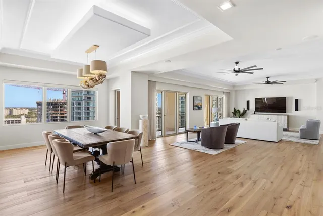 a view of a dining room with furniture and chandelier