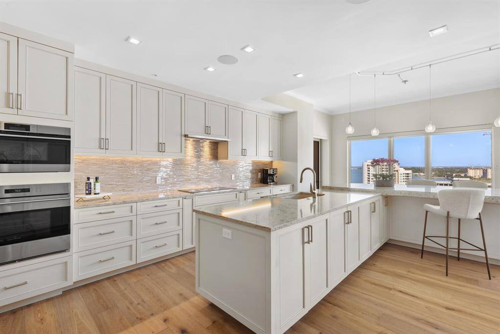 1111 Ritz Carlton Drive, Unit 1803 Sarasota, FL 34236 - Photo 20 of 65 a kitchen with white cabinets appliances and sink