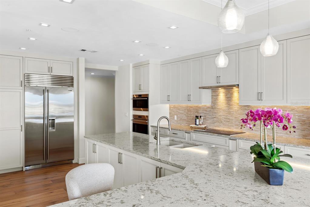 1111 Ritz Carlton Drive, Unit 1803 Sarasota, FL 34236 - Photo 23 of 65 a kitchen with stainless steel appliances kitchen island granite countertop a refrigerator and a sink