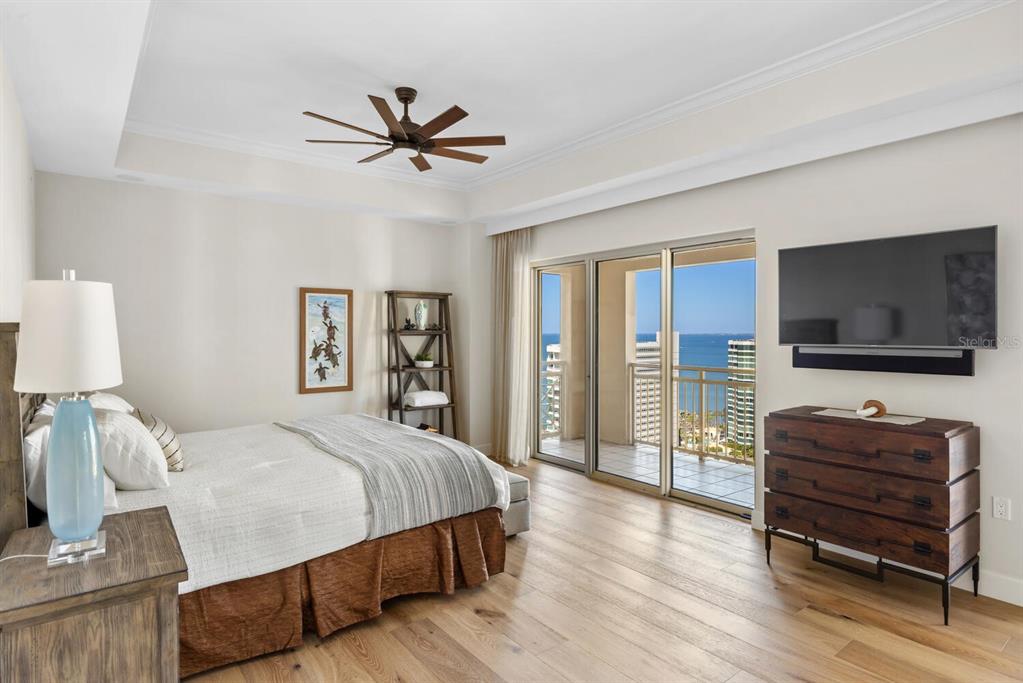 1111 Ritz Carlton Drive, Unit 1803 Sarasota, FL 34236 - Photo 26 of 65 a bedroom with a bed and a flat screen tv