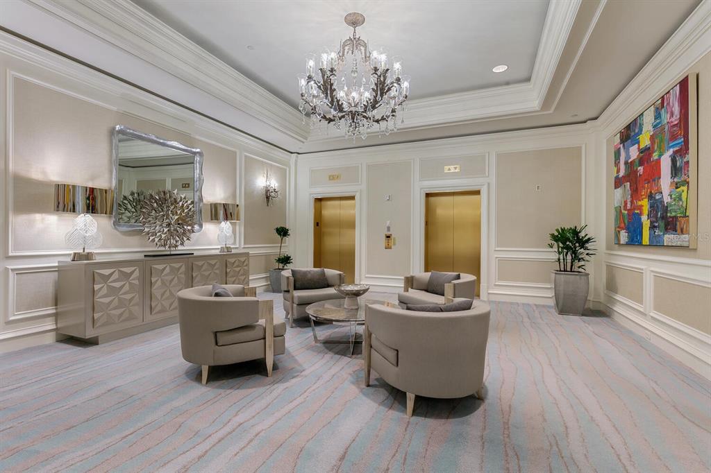 1111 Ritz Carlton Drive, Unit 1803 Sarasota, FL 34236 - Photo 4 of 65 a living room with furniture and a chandelier