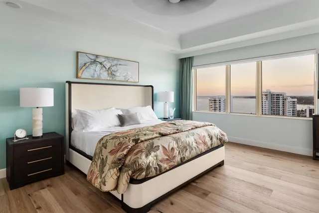 a living room with fireplace furniture and a large window