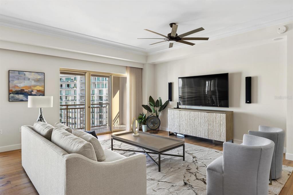 1111 Ritz Carlton Drive, Unit 1803 Sarasota, FL 34236 - Photo 8 of 65 a living room with furniture and a flat screen tv