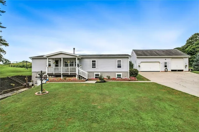 a view of a house with a yard and sitting area