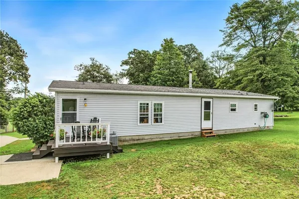 a view of a house with a backyard
