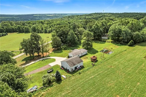 an aerial view of a house with yard swimming pool and outdoor seating