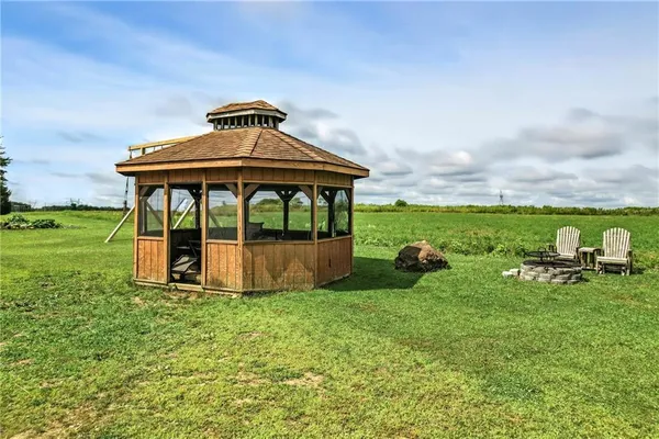 a view of a two chair and table in the garden