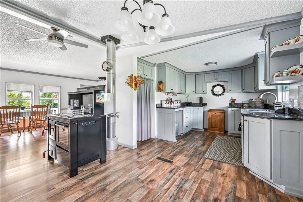 400 Oak Hill Road West Middlesex, PA 16159 - Photo 26 of 41 a kitchen with stainless steel appliances granite countertop a refrigerator a stove and a sink with cabinets