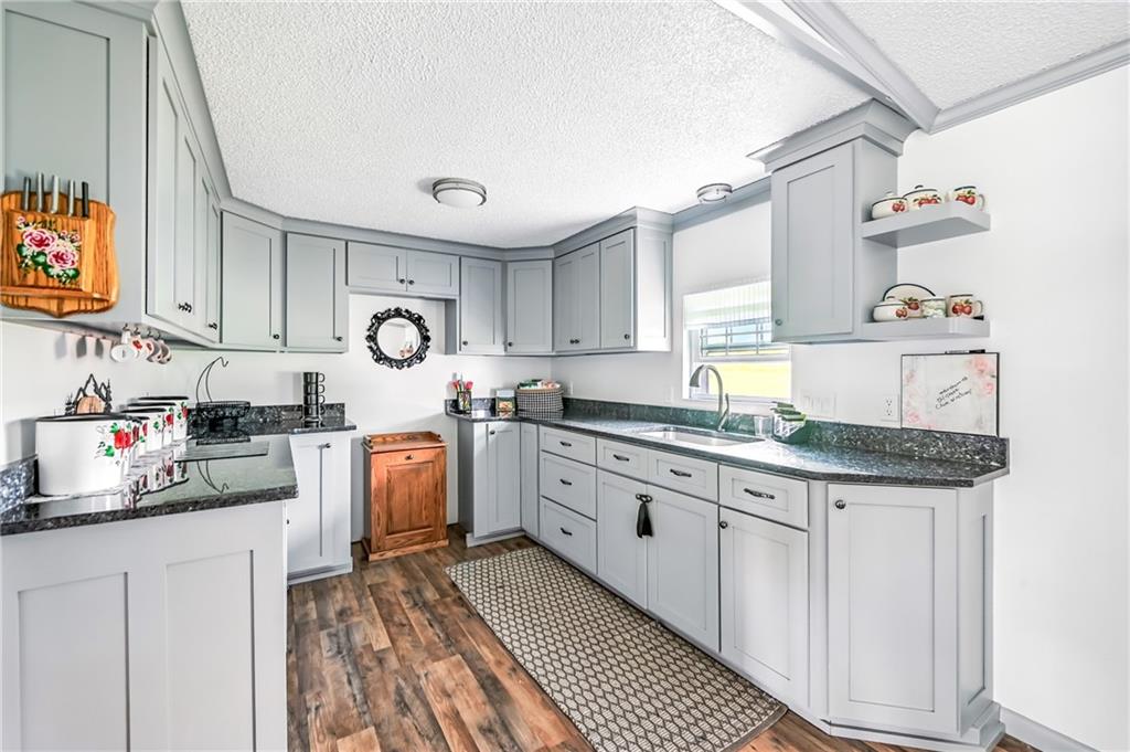 400 Oak Hill Road West Middlesex, PA 16159 - Photo 27 of 41 a kitchen with granite countertop a sink stove and cabinets