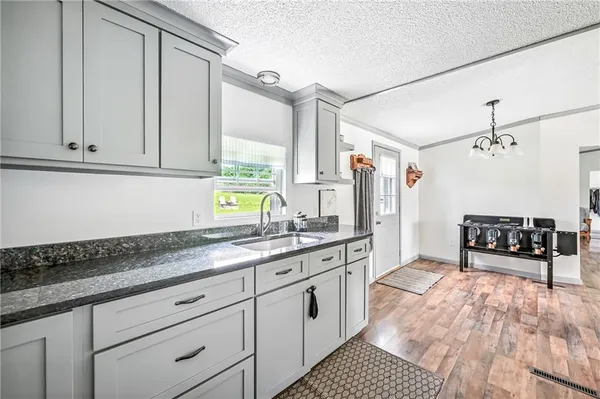 a kitchen with stainless steel appliances granite countertop a sink stove and cabinets