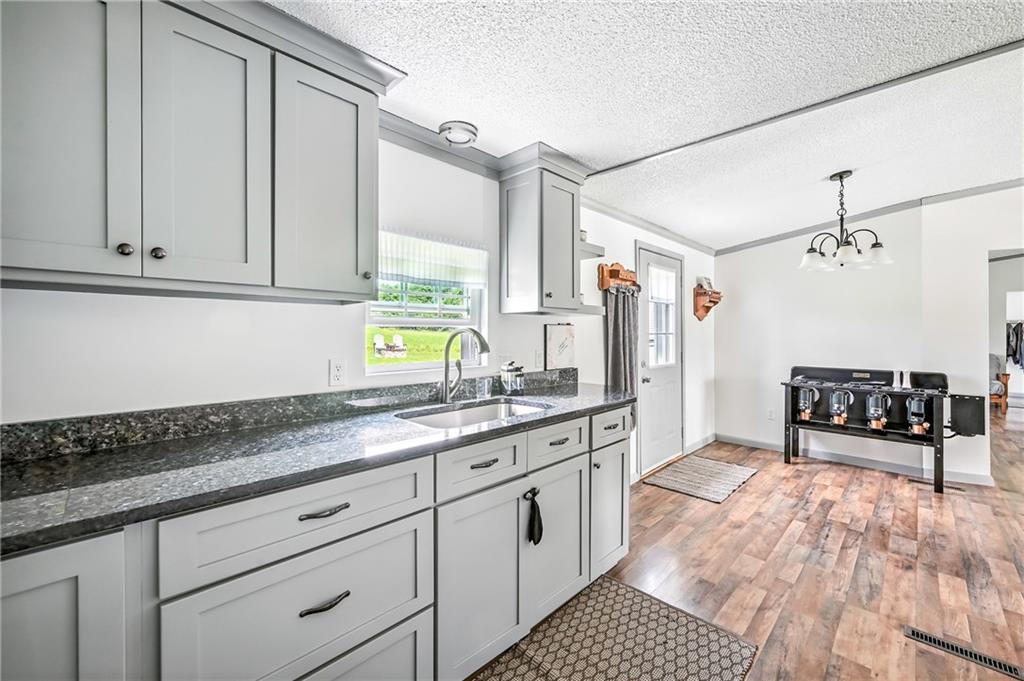 400 Oak Hill Road West Middlesex, PA 16159 - Photo 28 of 41 a kitchen with stainless steel appliances granite countertop a sink stove and cabinets