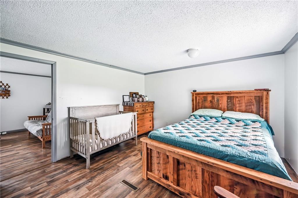 400 Oak Hill Road West Middlesex, PA 16159 - Photo 29 of 41 a bedroom with a bed and wooden floor