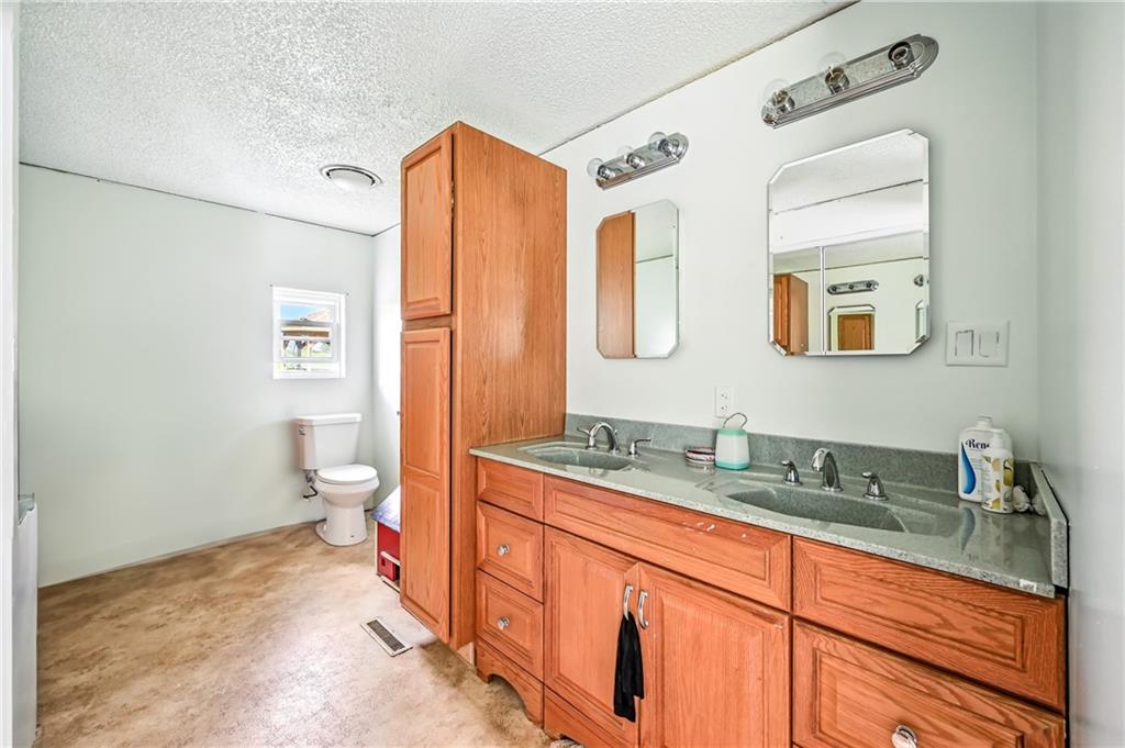 400 Oak Hill Road West Middlesex, PA 16159 - Photo 30 of 41 a spacious bathroom with a granite countertop sink mirror and toilet